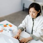 woman types at computer on desk