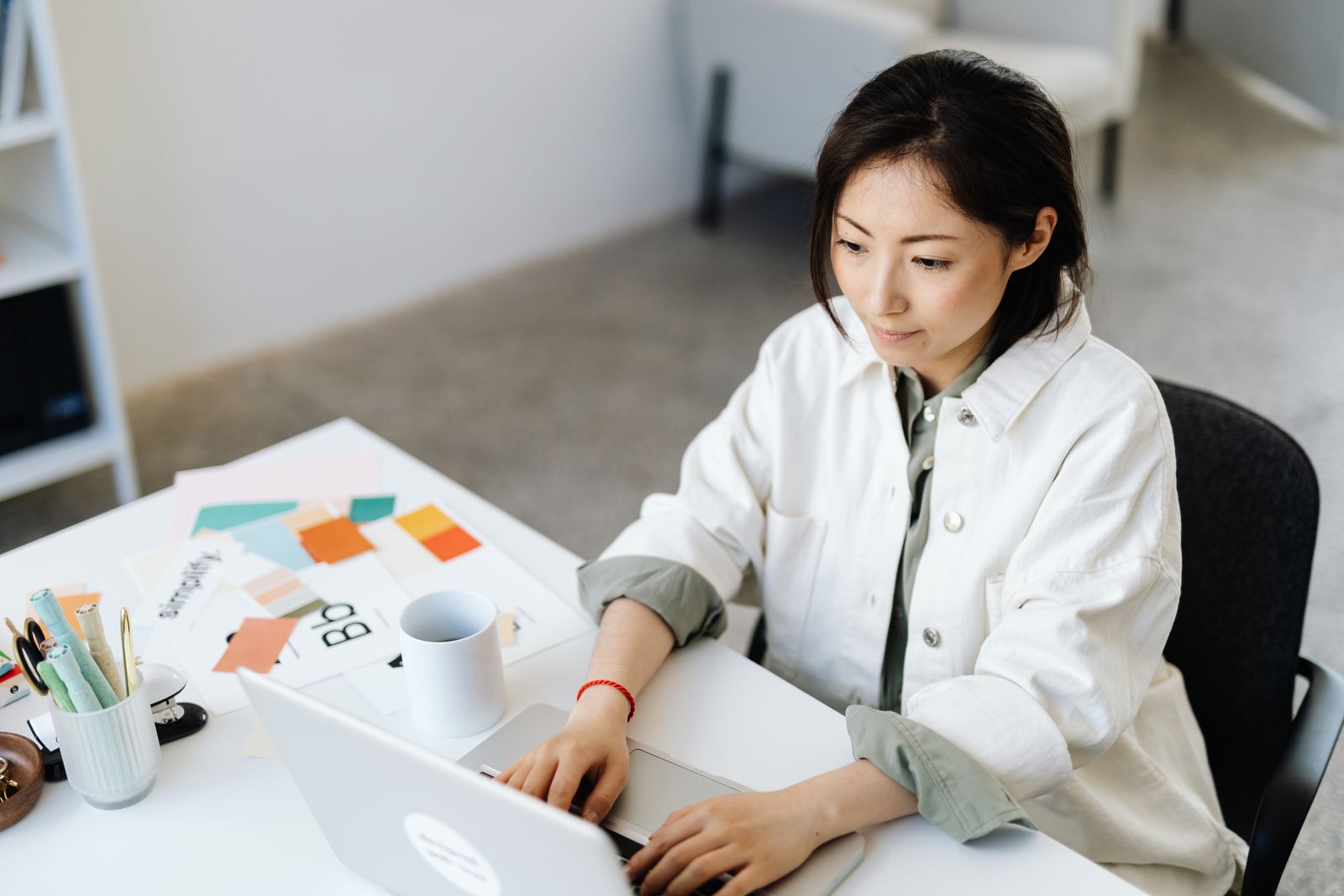 woman types at computer on desk